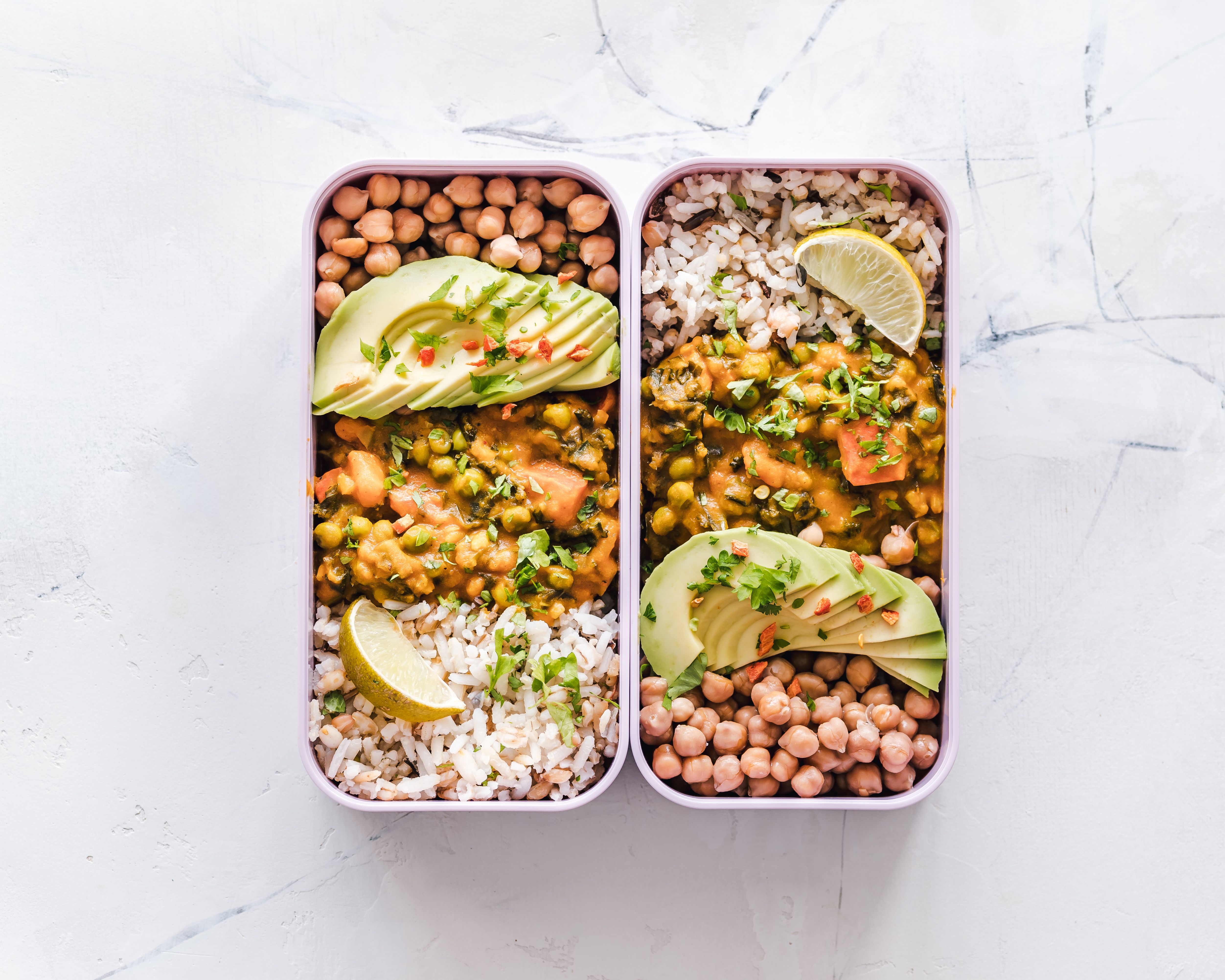 Fresh groceries and meal prep containers organized in a kitchen